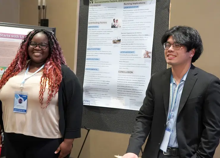 Student presenting poster to a small group